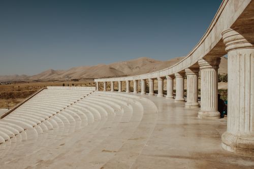 Free Stunning view of an ancient Greek amphitheater with classical columns under a clear blue sky. Stock Photo