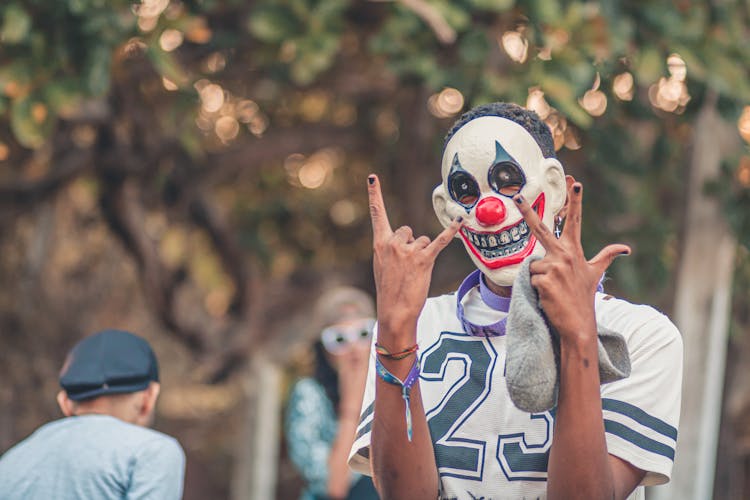 Man In A Mask Showing A Gesture With Hands