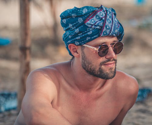 Man Wearing Blue and White Headscarf and Sunglasses 