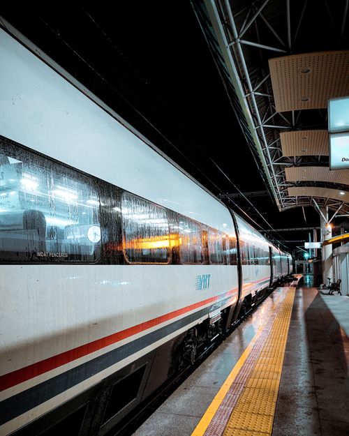 Free A sleek train at a dimly-lit station platform, capturing a modern transportation scene at night. Stock Photo