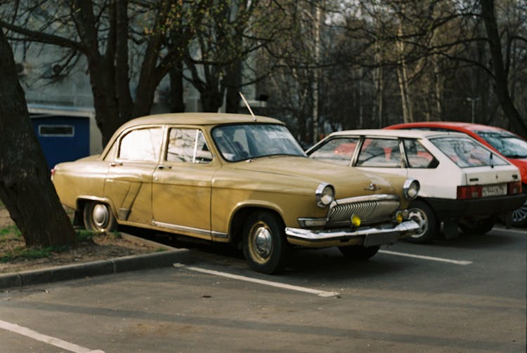 Photograph Of Vintage Cars In A Parking Lot