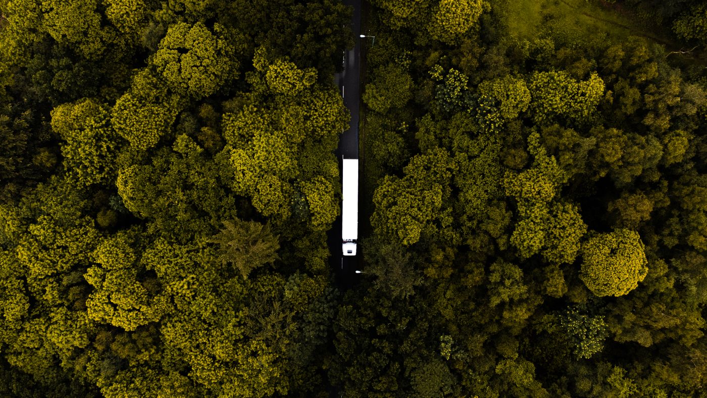 Aerial view of a semi truck driving along a road