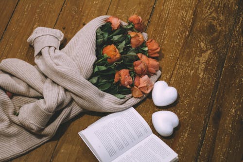 Overhead Shot of a Bouquet of Flowers and an open Book