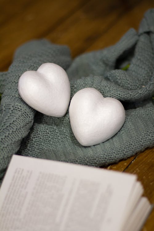 Free Heart-shaped Styrofoam Beside a Book  Stock Photo
