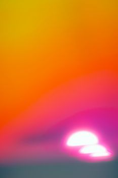 Colorful abstract image of a sunset with blending orange, yellow, and pink hues.