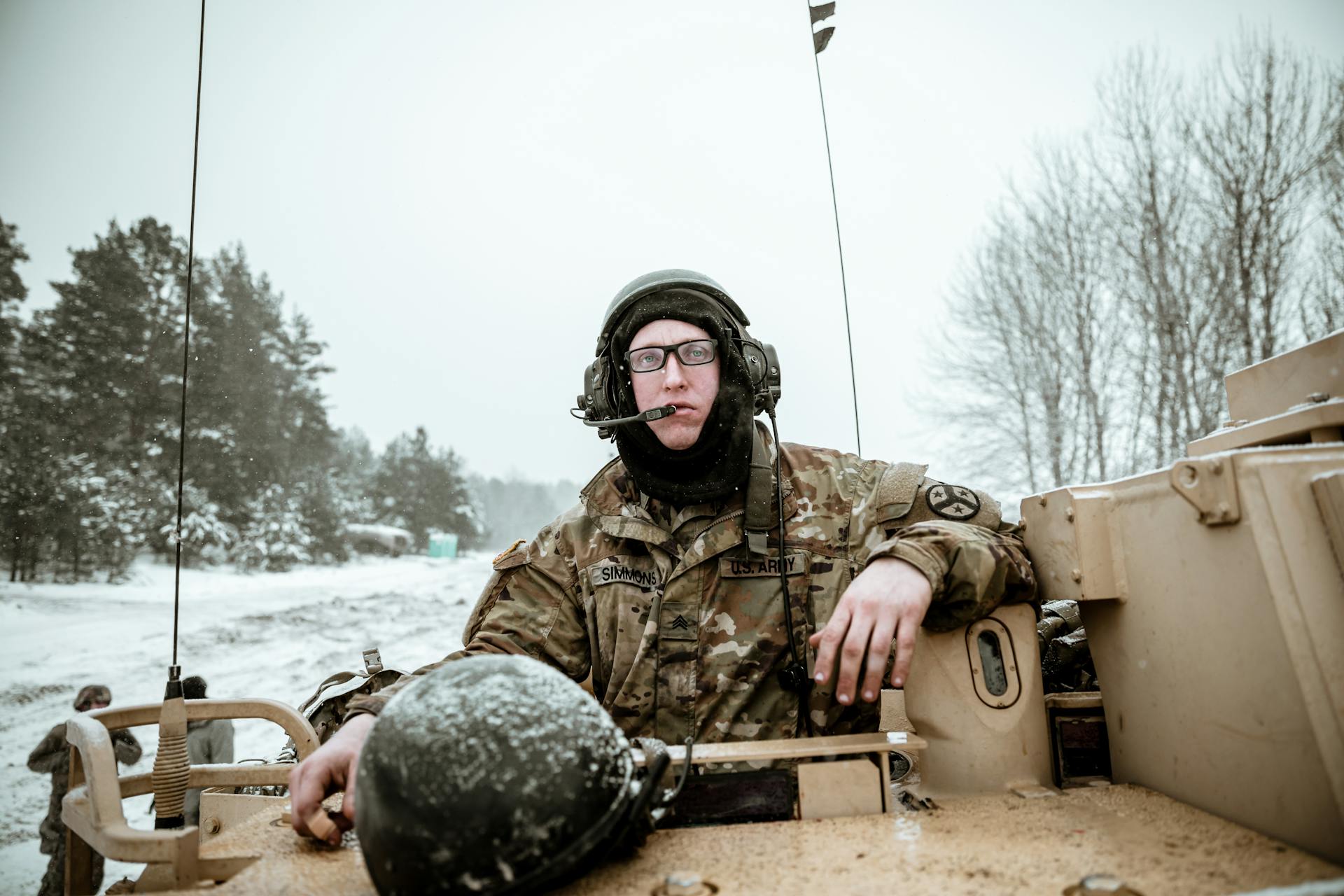 A Military Personnel Riding a Tank