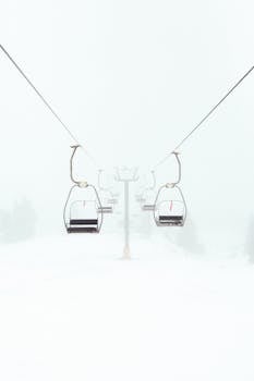 Empty ski lift in foggy winter scene highlighting outdoor adventure