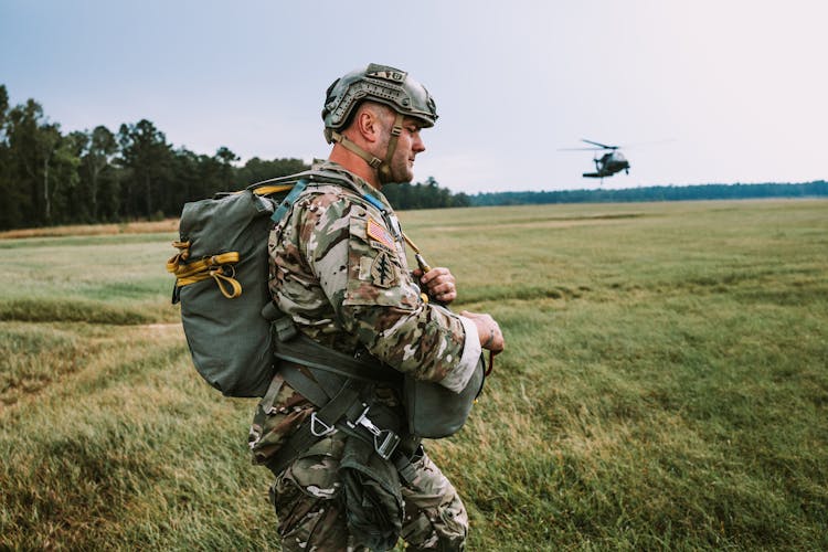 A Soldier Walking On A Field