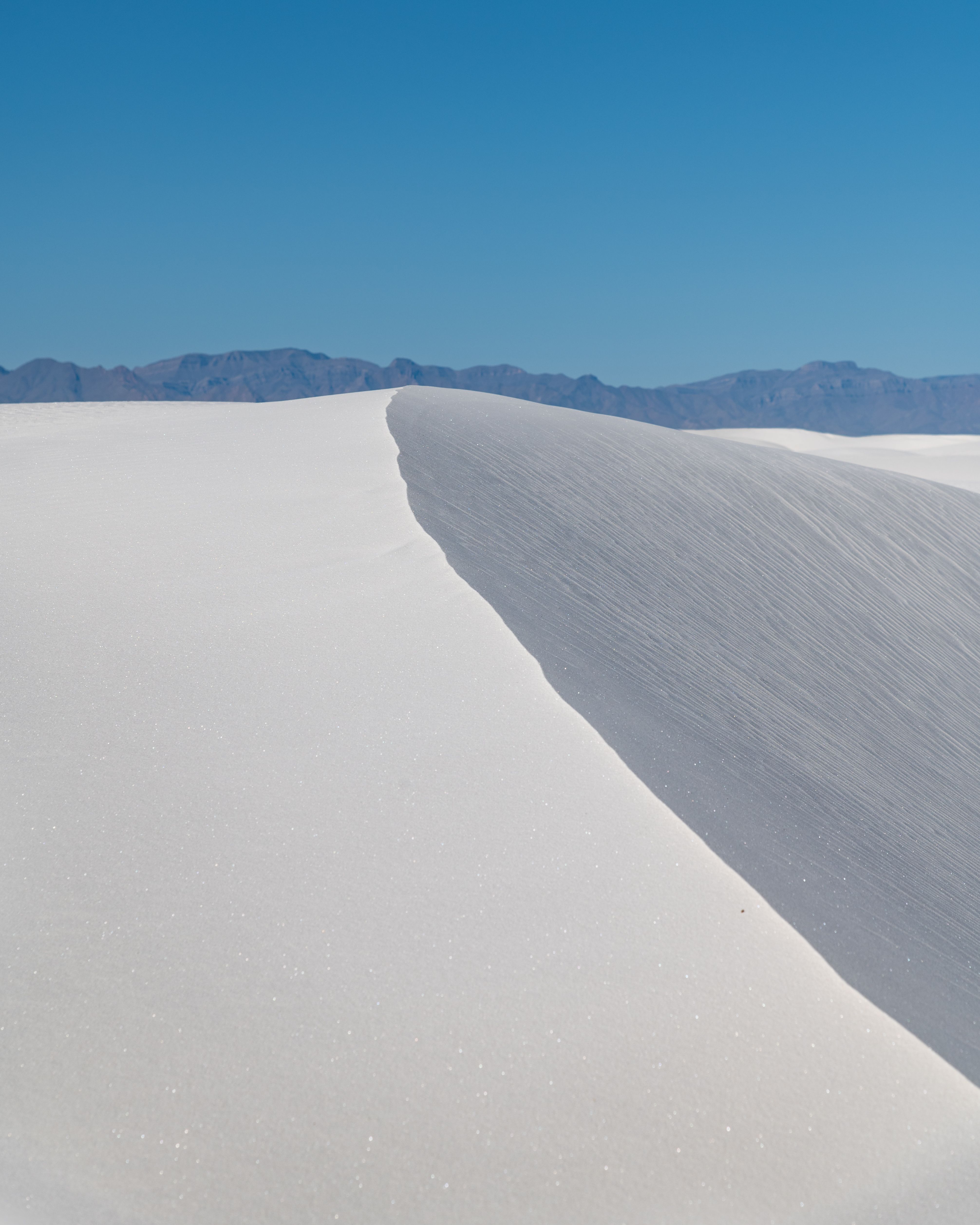 White Sands National Monument with bright dunes and clear blue sky in New Mexico.
