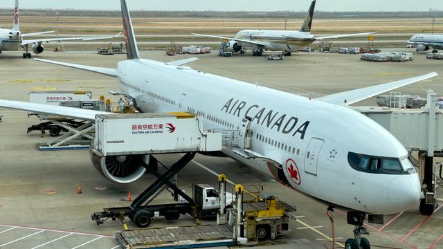 Air Canada airplane being serviced at Shanghai Pudong Airport. Busy tarmac with multiple aircraft. — lounges at Shanghai Pudong Airport