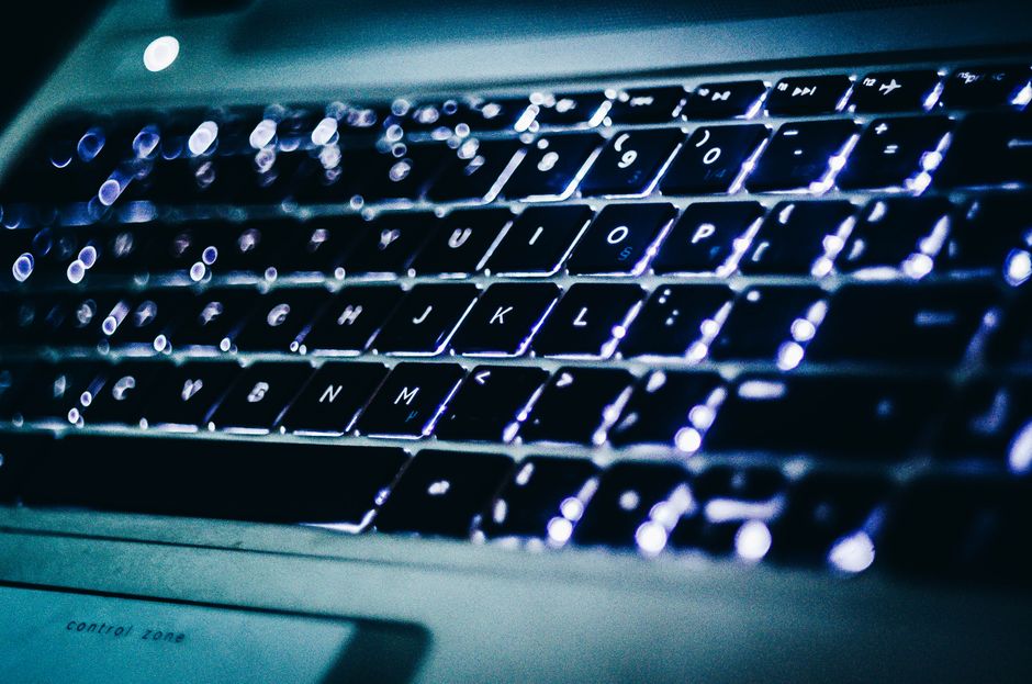 A detailed view of a glowing laptop keyboard, capturing the essence of modern technology and connectivity.