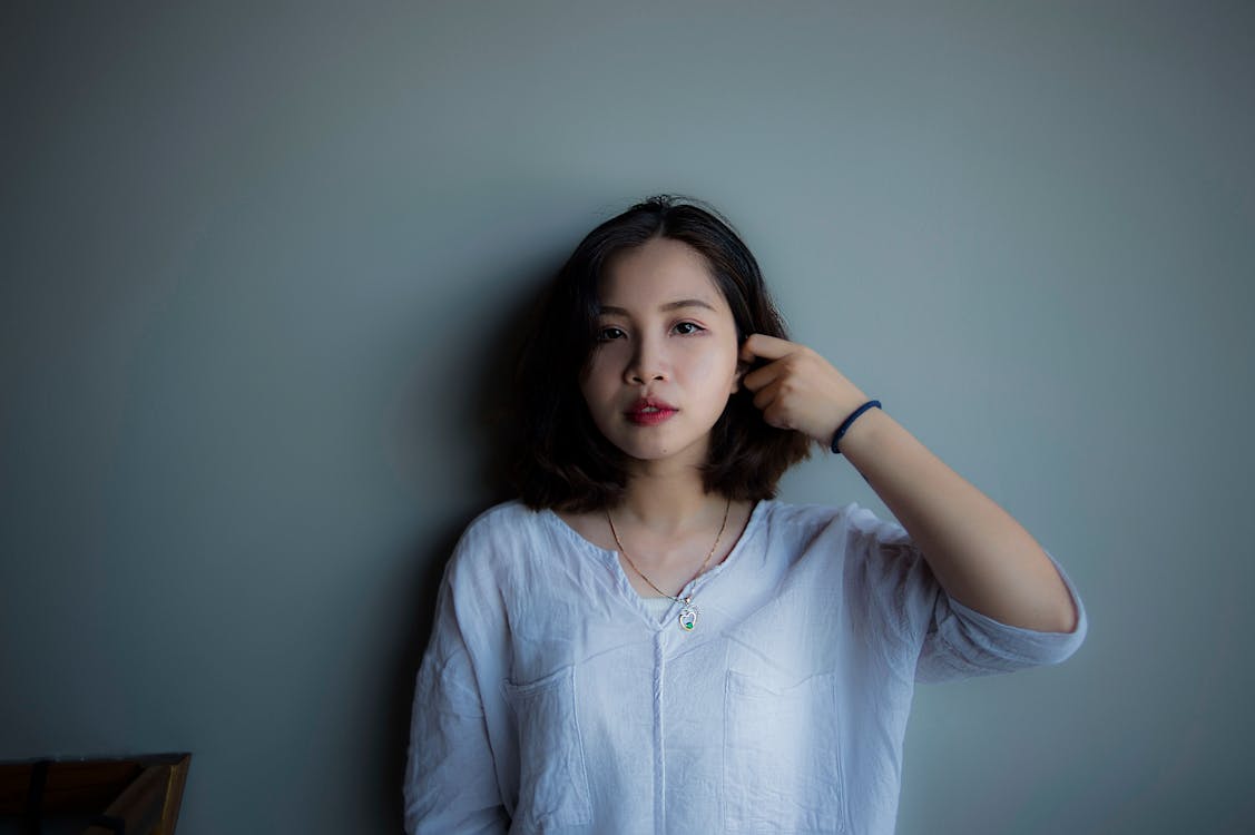 Free Woman Wearing Blue Long-sleeved Shirt Stock Photo