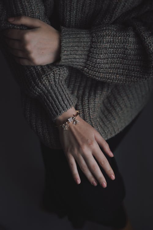 Woman in Gray Knit Sweater Wearing a Bracelet · Free Stock Photo