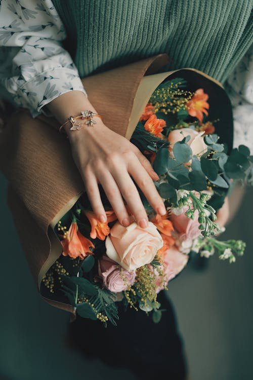 Free Woman Holding a Bunch of Flowers  Stock Photo