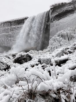 Stunning frozen waterfall amidst icy landscape, capturing the beauty of winter.