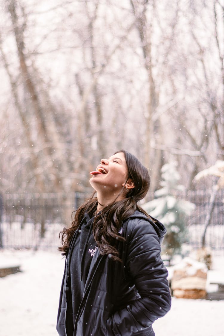 Woman Catching Snow With Tongue