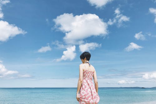 Back View of a Woman Standing by the Seaside