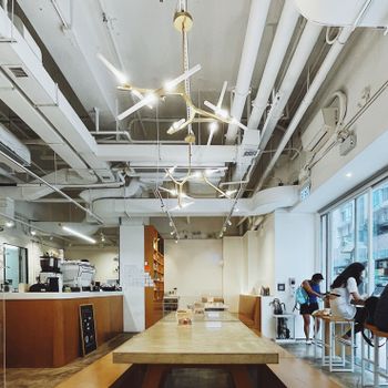 Stylish cafe interior with modern lighting and comfy seating, perfect for socializing.