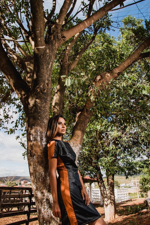 Woman Leaning on Tree