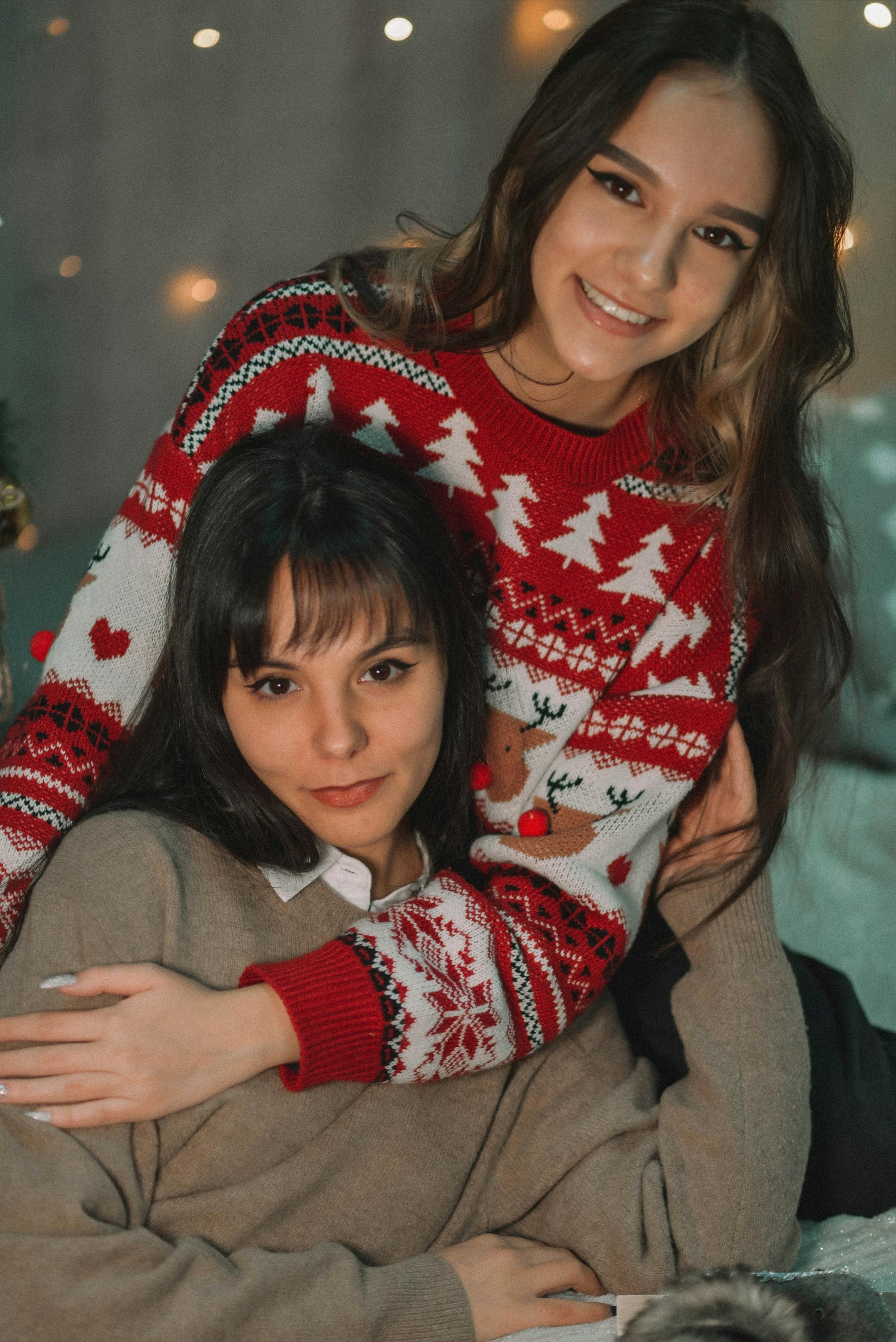 young women in sweaters posing together