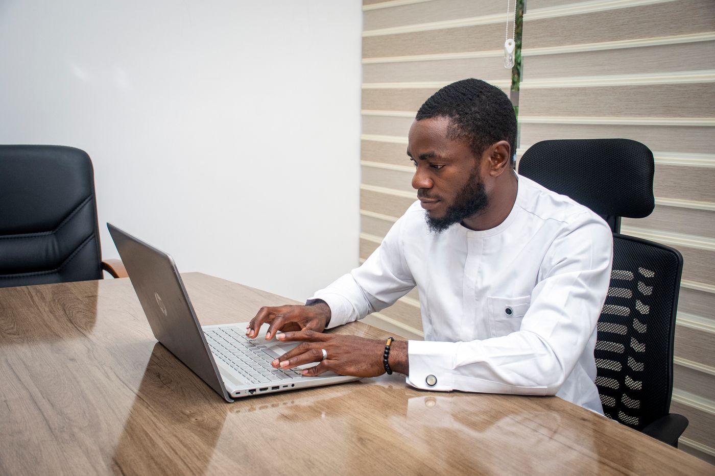 Nigerian professional using a laptop for digital work