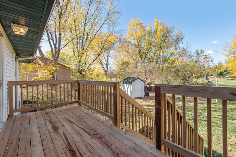 Spacious wooden deck with beautiful backyard view