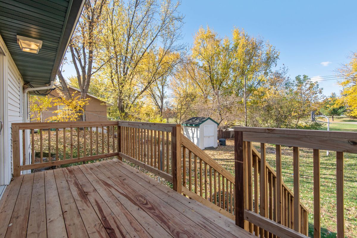 Rebuilt backyard wooden deck with railing on a New York home