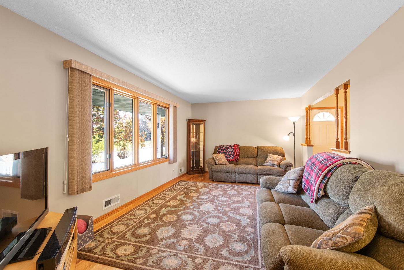 Bright inviting living room with cosy sofas and large windows
