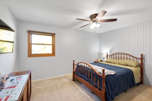 Brown Wooden Bed Frame Inside a White Room