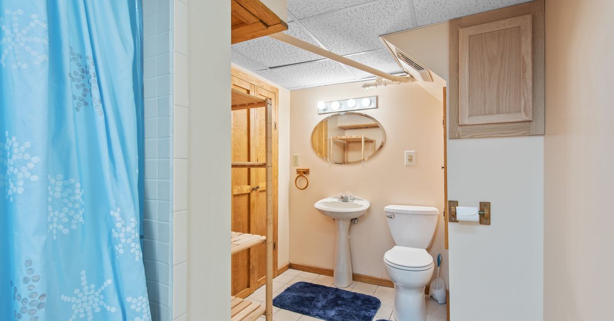 Clean and modern bathroom featuring a sink, toilet, and shower area.
