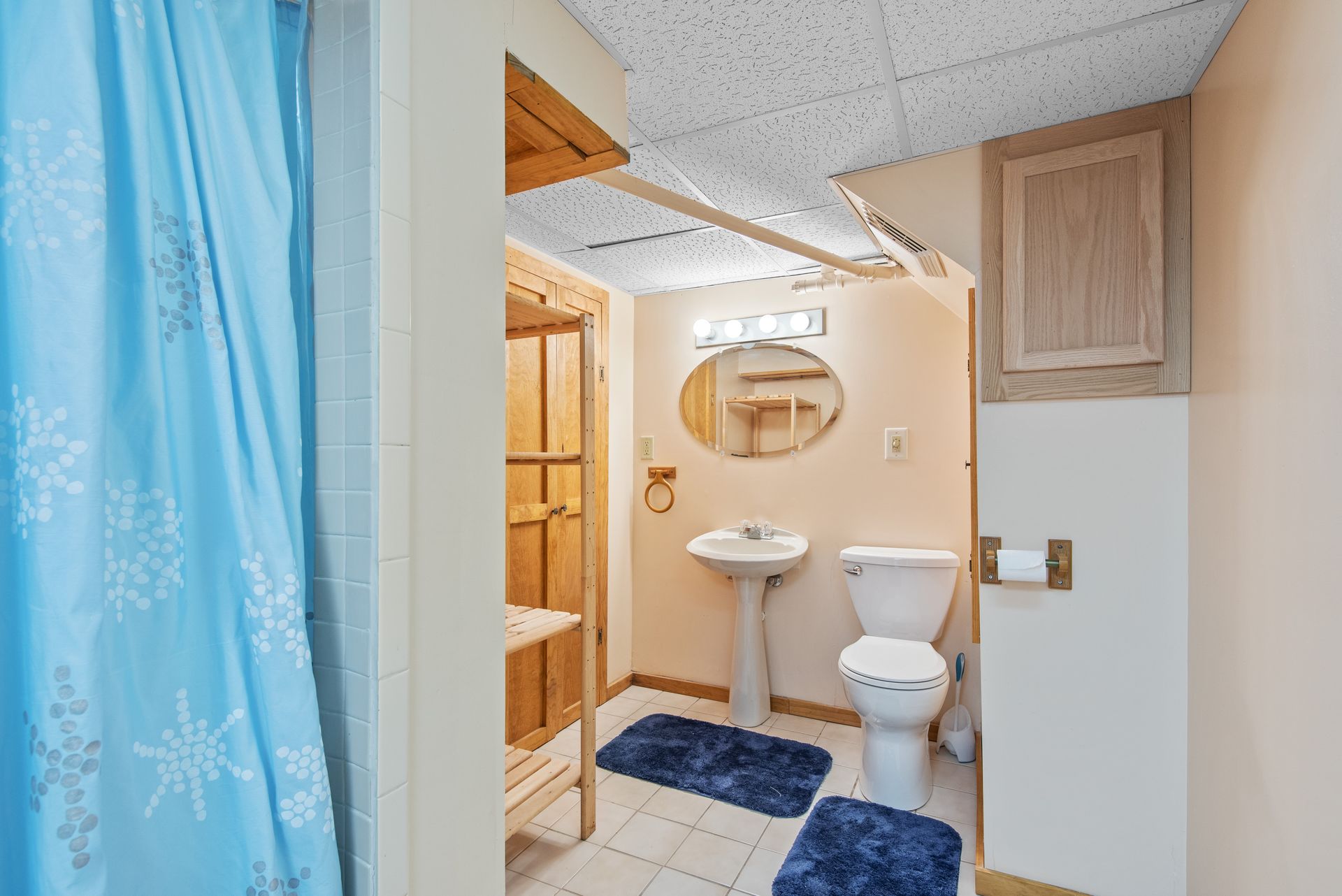 Clean and modern bathroom featuring a sink, toilet, and shower area.