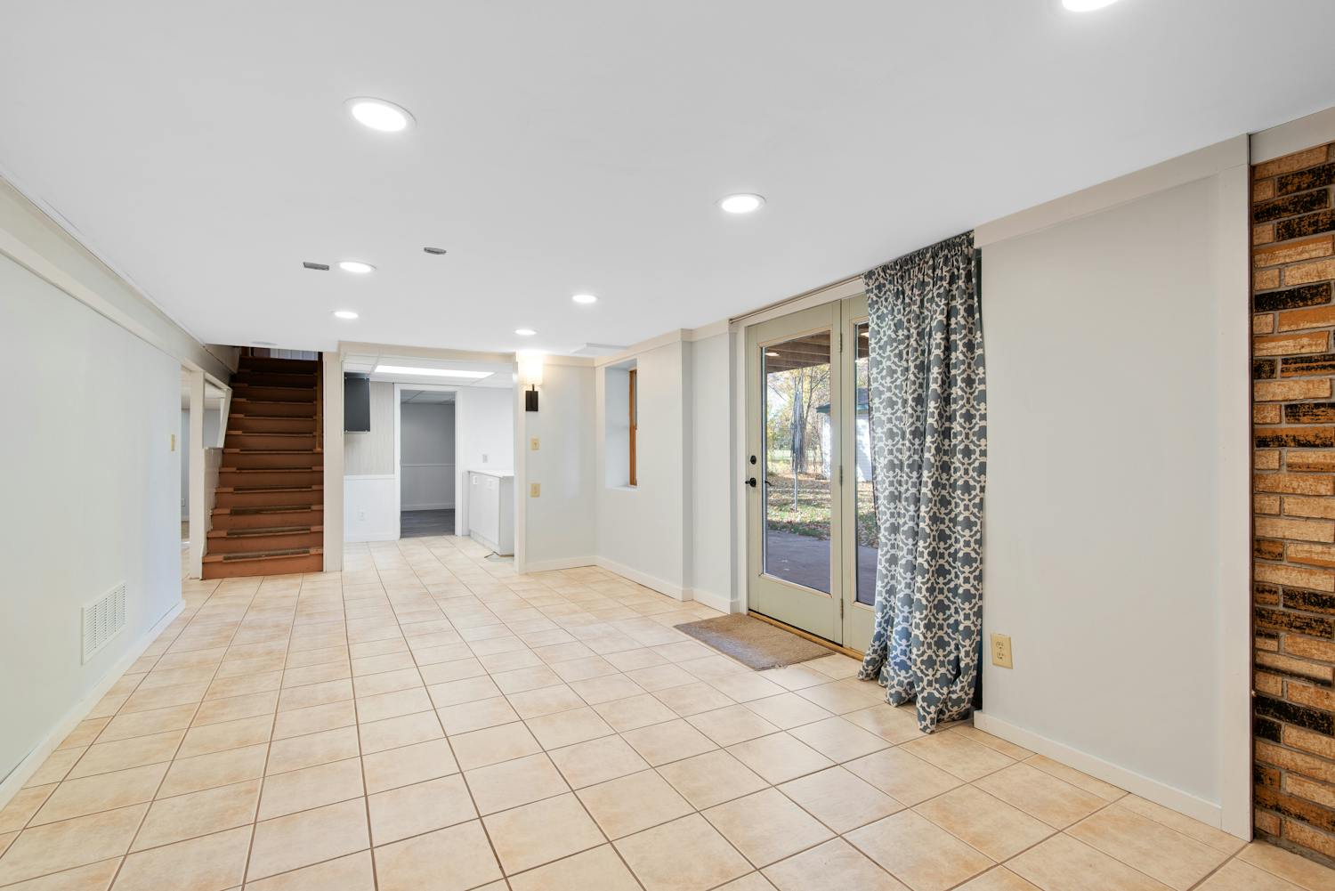 Basement transformation in Verdun showing bright multi-purpose living suite