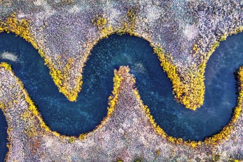 Free A mesmerizing aerial shot of a meandering river in a snowy winter landscape near Rochester, MN. Stock Photo