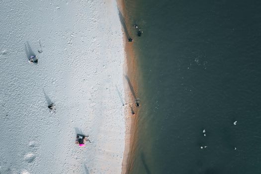 A stunning top view of a sandy beach meeting the ocean in Chukai, Terengganu, Malaysia.