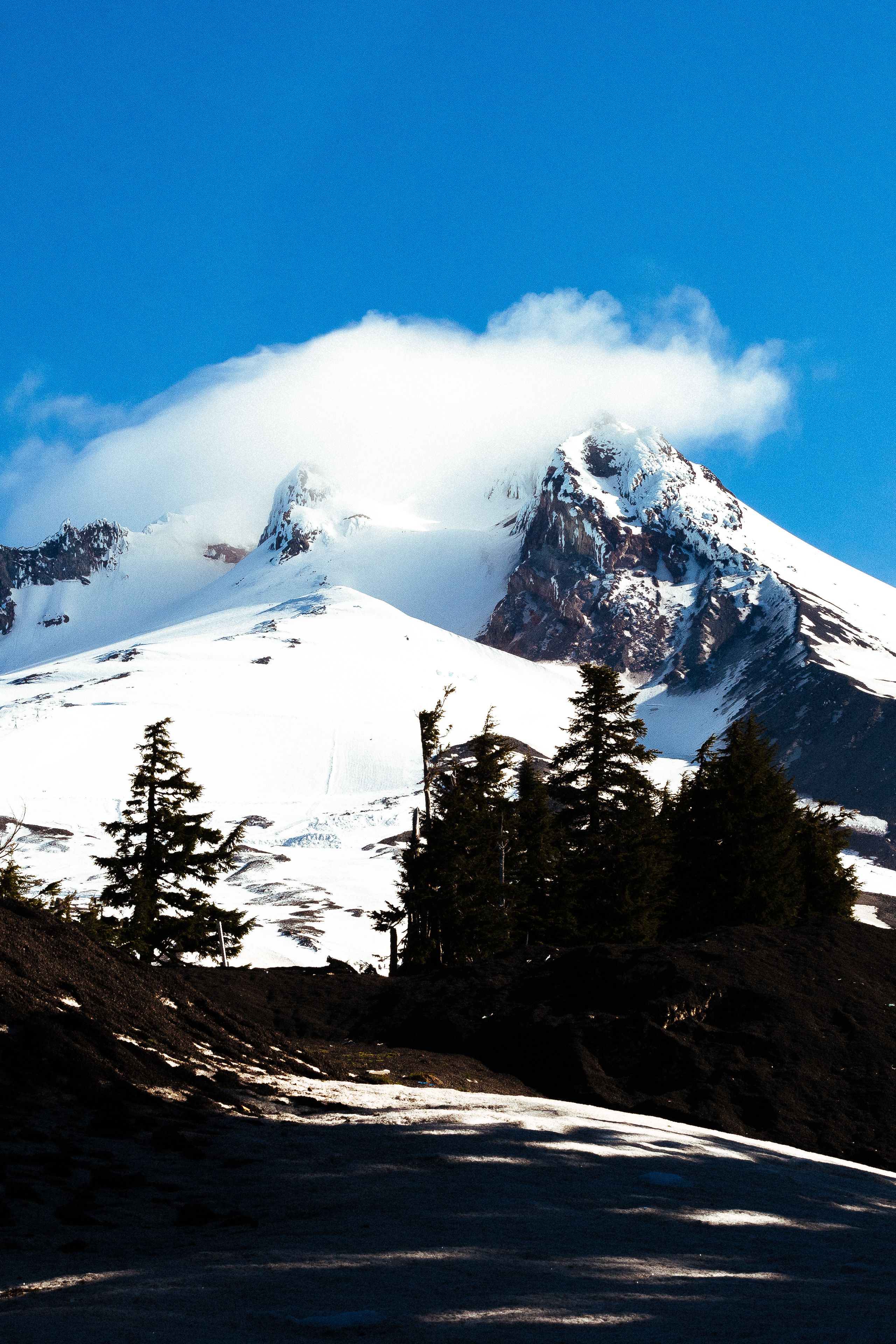 Snow Covered Mountain Under Cloudy Sky · Free Stock Photo