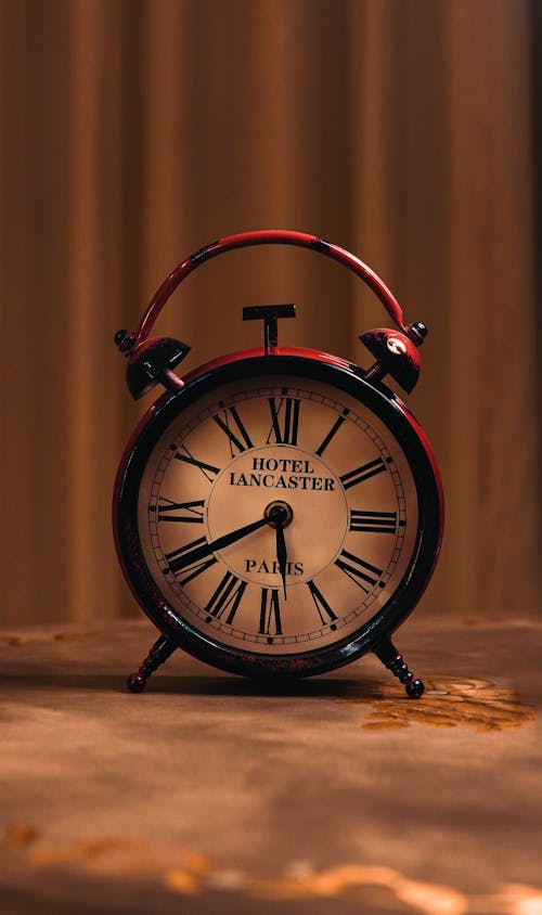 Close Up Photo of a Red Analog Clock