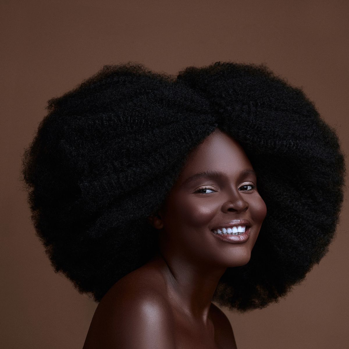 Smiling Black woman with a natural Afro hairstyle