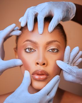 A close-up portrait of a woman with gloved hands framing her face, showcasing beauty and healthcare concepts.