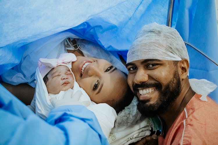 Photo Of Couple With Their Newborn Baby In The Hospital