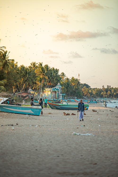 People on Beach and Boats on Shore