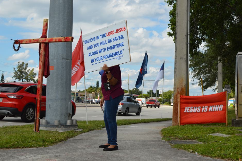 man holding christian flag