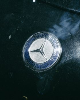 Close-up photograph of a Mercedes Benz emblem on a car in Fes, Morocco. 10852802