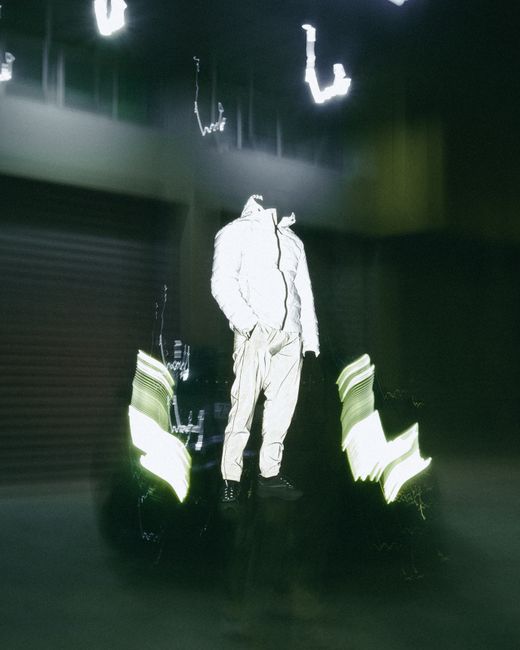 Captivating image of a reflective person blending into a dark urban environment, creating a surreal effect.