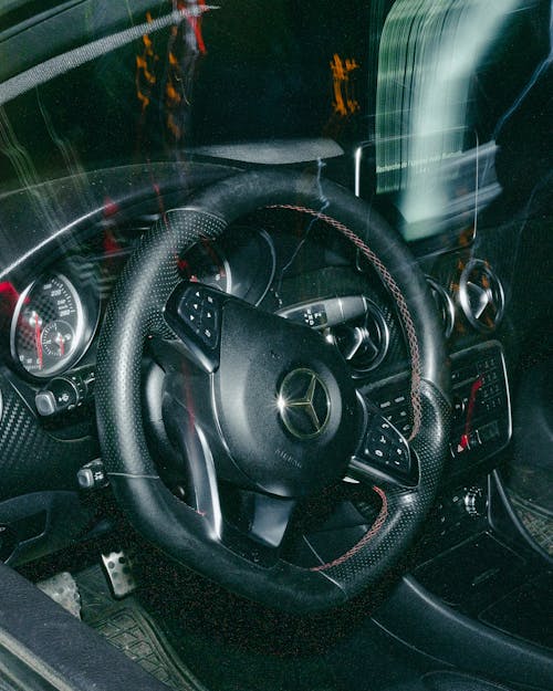 Close-Up Shot of a Black Car Steering Wheel