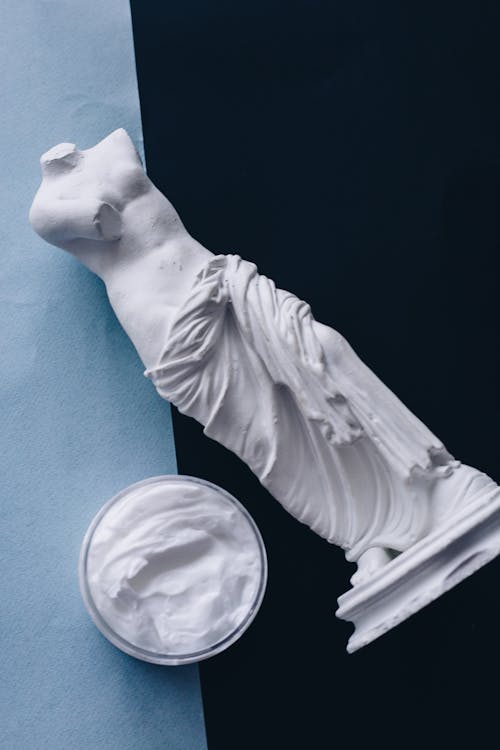 White Ceramic Angel Figurine on Blue Textile