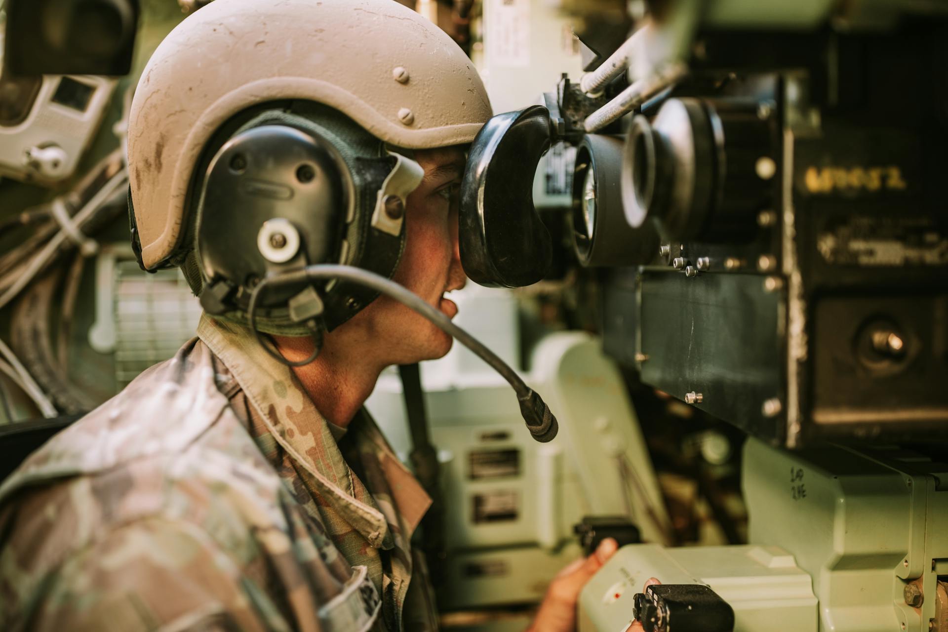 Soldier in Uniform Working with Military Equipment