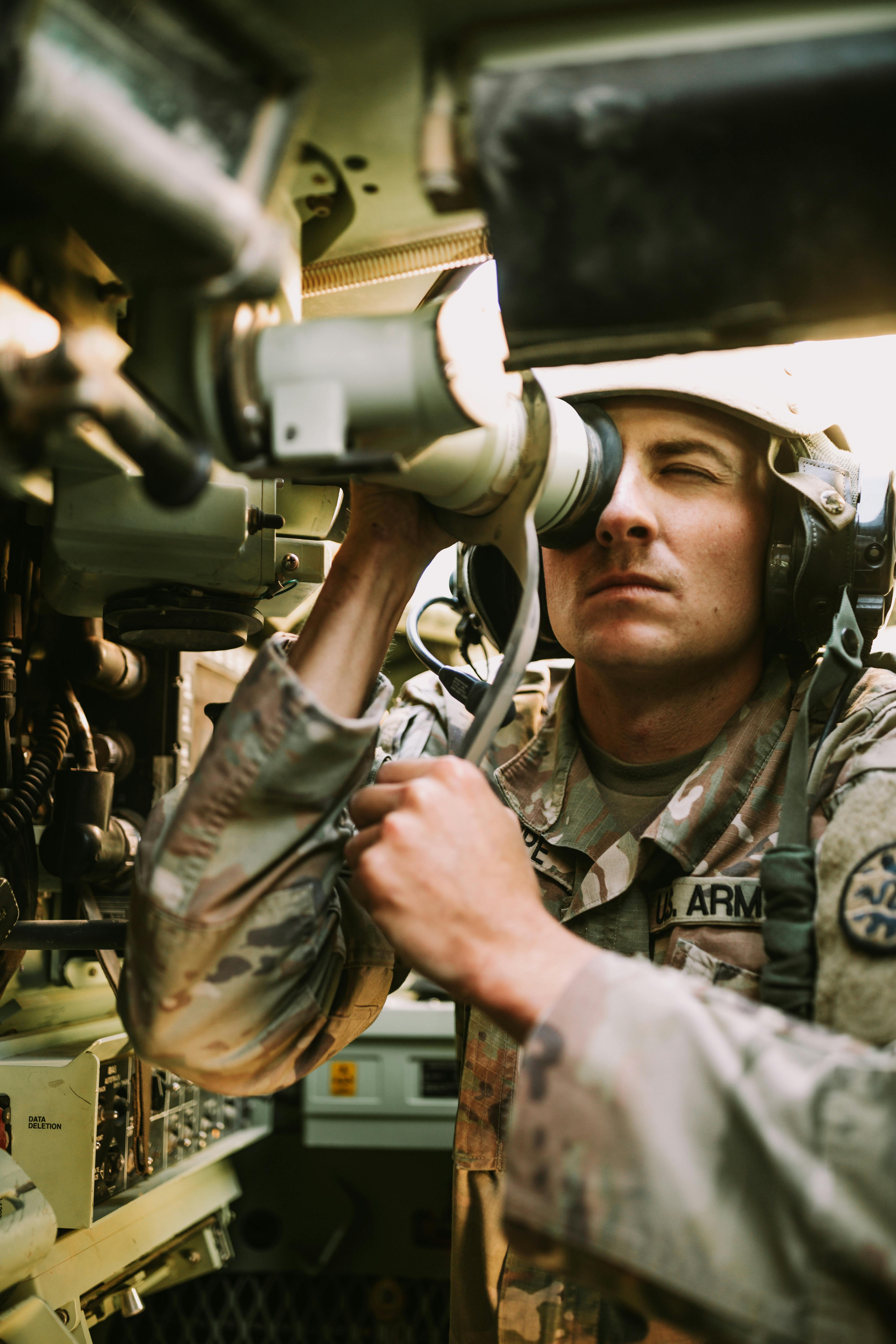 soldier looking through periscope