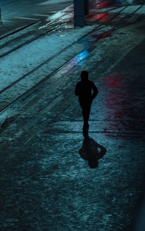 Silhouette of Person Walking on Street During Night Time · Free Stock Photo