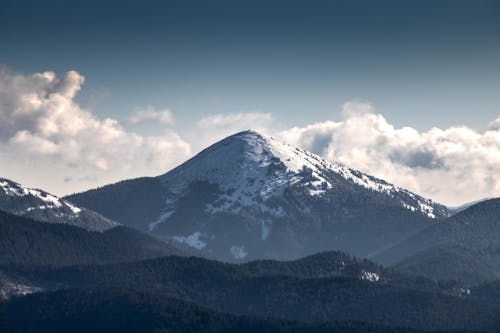 Free Snow Covered Mountain Surrounded By White Clouds Stock Photo