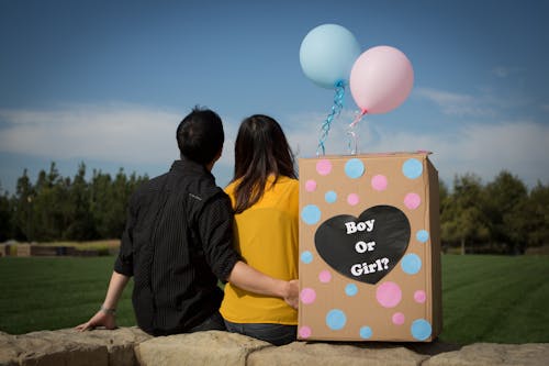Free Man and Woman Holding Balloons Stock Photo